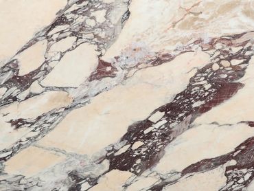 Marble surface with intricate grey and reddish-brown veining patterns.