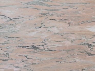 Pink marble surface with natural veining patterns.
