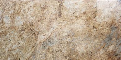 Close-up of a textured beige and brown granite surface.