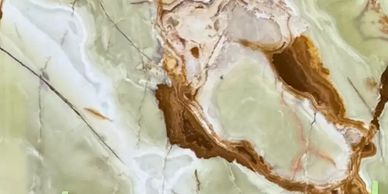 Close-up of a polished marble surface with green and brown veins.