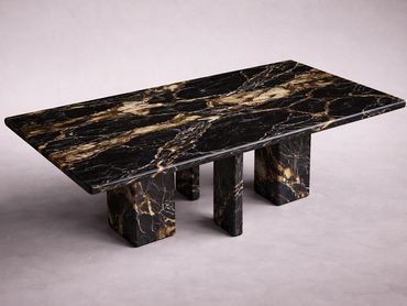 Rectangular black marble table with gold veins and three block legs.
