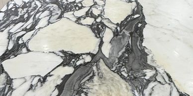 Close-up of a white marble surface with black and gray veining.