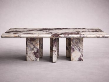 Rectangular marble table with thick legs and intricate veining.