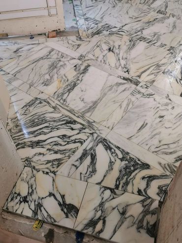 Polished marble floor tiles with intricate black and white veining.