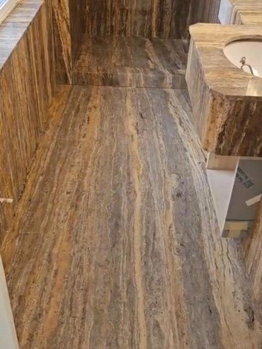 Luxurious bathroom with marble walls and flooring.