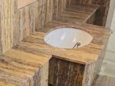 Elegant marble countertop with a built-in sink in a bathroom.