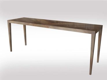 Sleek rectangular wooden table with a polished finish and tapered legs.