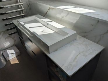 Modern double sink with marble countertop in a bright bathroom.
