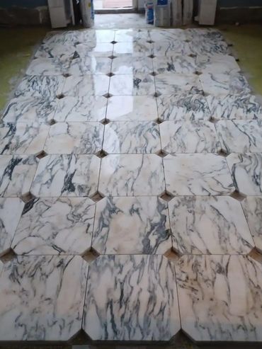 Marble tiles laid out in a geometric pattern on the floor.
