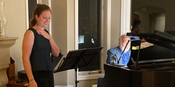 Katrina Zosseder, soprano, and Joe Bloom, pianist perform at a house concert.