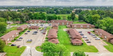 Aerial view of a residential apartment complex with parking lots.