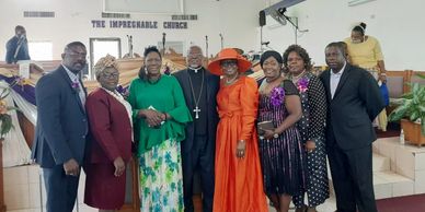 Group of people dressed formally posing inside a church.