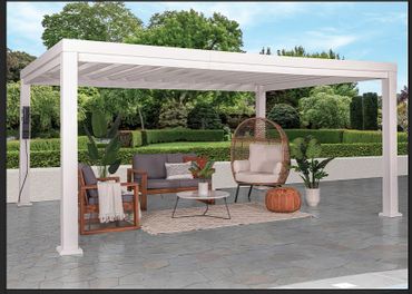 Modern outdoor patio with white pergola and cozy seating area.
