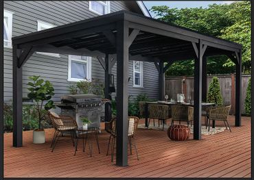 Modern backyard pergola with outdoor dining and grill setup on wooden deck.