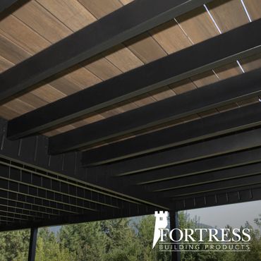 Modern pergola with dark beams and wooden slats overhead.