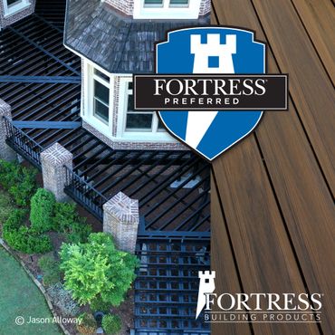 Decorative metal railing around a house with Fortress branding.