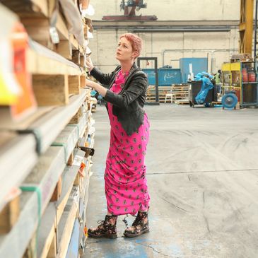 Kirsty inspecting packs of stainless steel in her factory