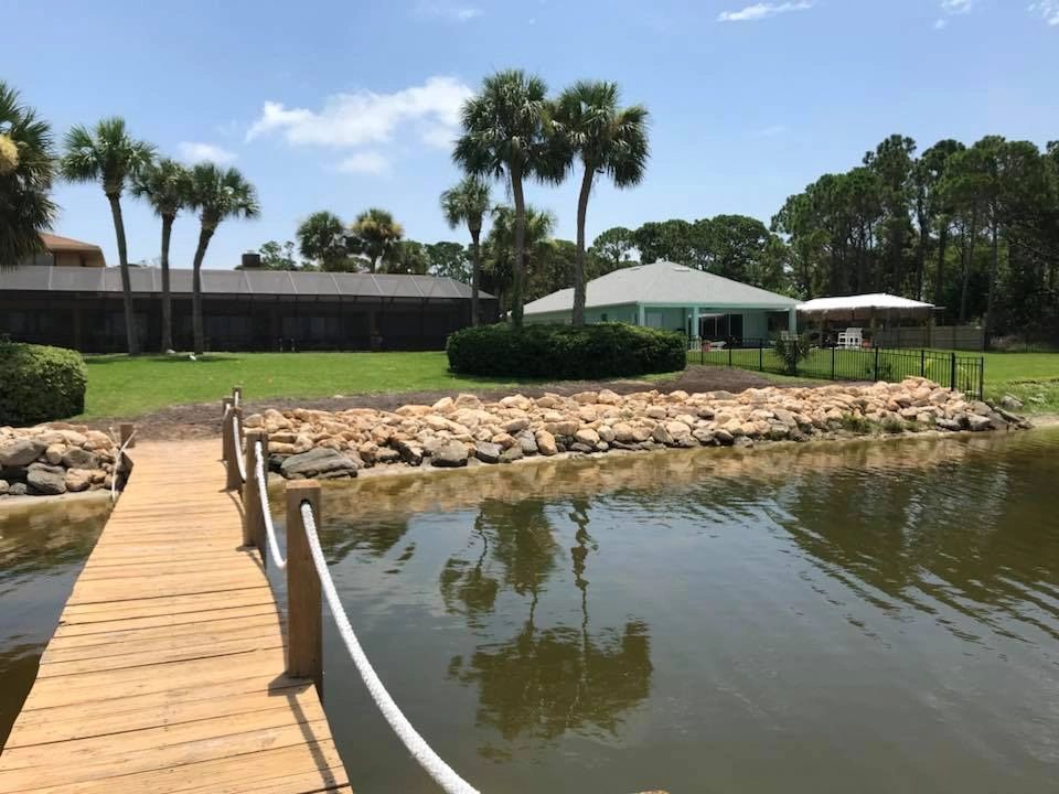 Rock seawall installation on Merritt Island using coquina rock revetment.