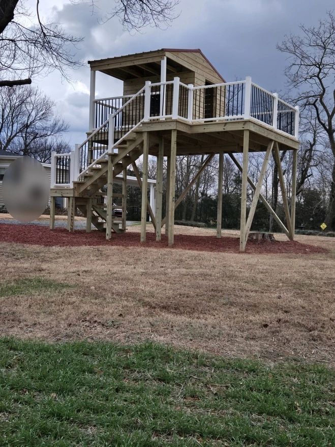 Elevated kids' playhouse with  platform deck and stairs