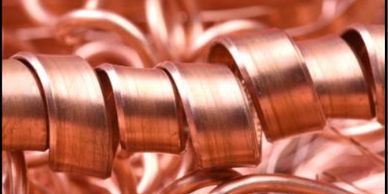 Close-up of shiny, coiled copper wire.