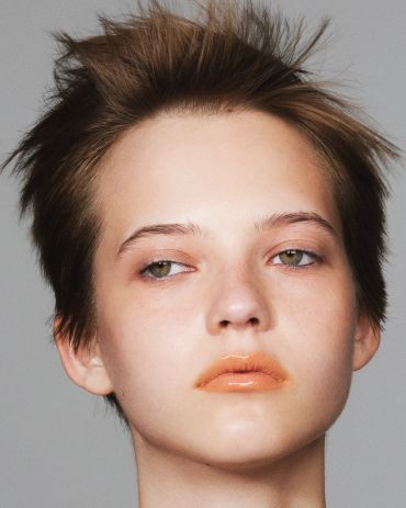 Close-up portrait of a person with short, tousled hair.