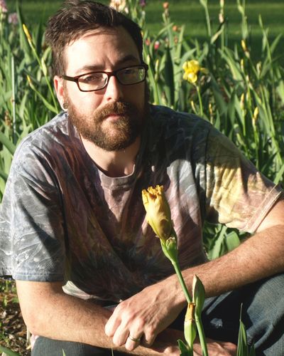 Me next to my very first hybridized iris getting ready to bloom. 