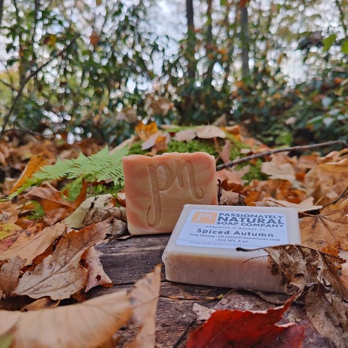 Two bars of Spiced Autumn Vegan Soap on the ground with autumn leaves background.