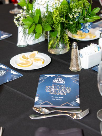 Table setting for engineering awards ceremony with floral centerpiece.