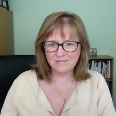 Picture of Sue Stradling in her therapy room, looking into camera