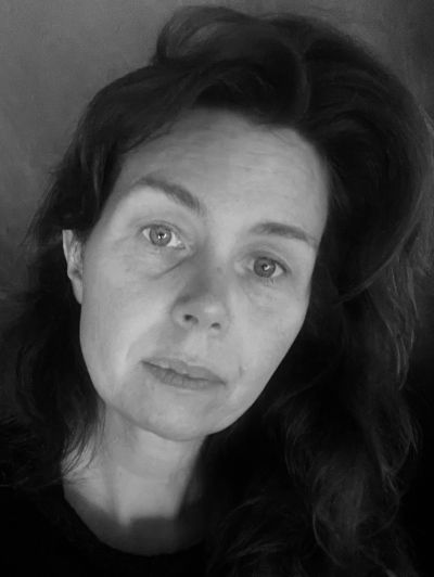 Black and white portrait of a woman with loose hair.