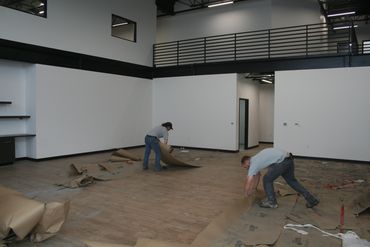 Crew removing debris from construction site floor in Chippewa Falls