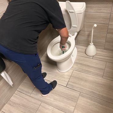 technician performing restroom cleaning at an eau claire business