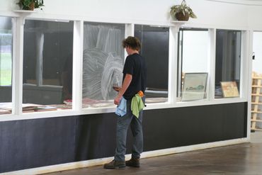 crew technician washing windows at the northern wisconsin state fairgrounds