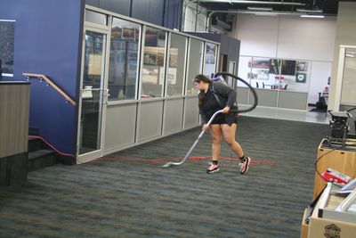 J & F Facility Services team member vacuuming a retail store in Eau Claire Wisconsin