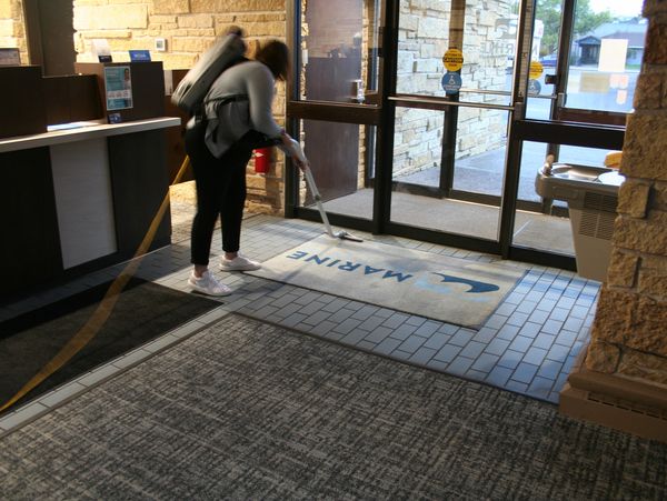 J & F Facility Services team member vacuuming inside a bank in Chippewa Falls, Wisconsin