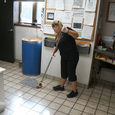 janitorial cleaning technician mopping an office at warehouse in chippewa falls