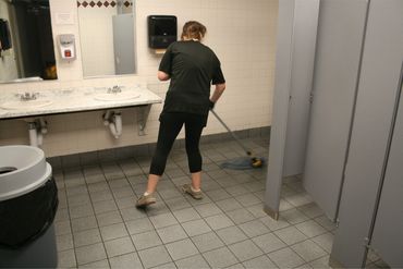 cleaning technician for j & f facility services cleaning a warehouse bathroom in eau claire wi