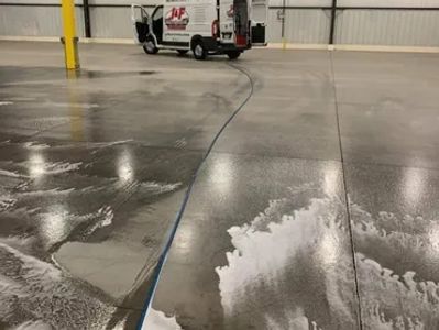 J & F Facility Services team performing floor stripping and waxing at a warehouse in Eau Claire WI