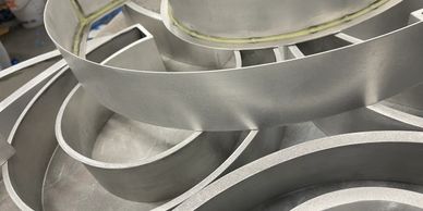 Close-up of curved metallic strips arranged in a spiral pattern.
