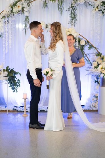 Bride and Groom under the wedding arch