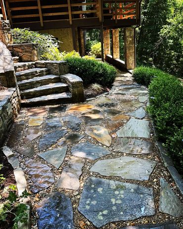 stunning flagstone walkway featuring  river rock accents and stone edging. Pathway in  garden patio