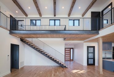 A wooden staircase with wrought iron railing