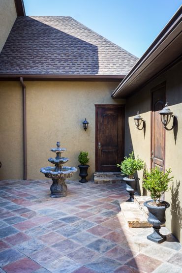 A tiled backyard with an old fountain