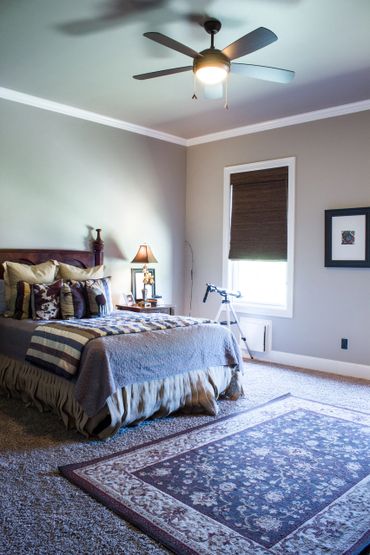 A room with a light grey wall and bedsheets