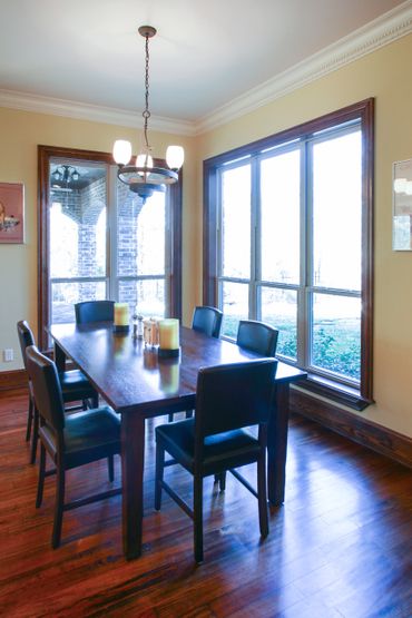 A dining area beside two large windows