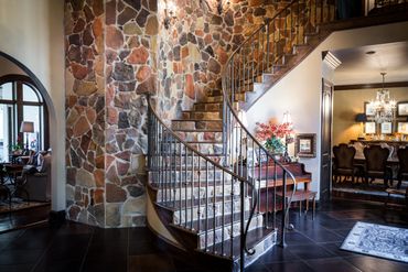 A curved staircase with brick-like tiles