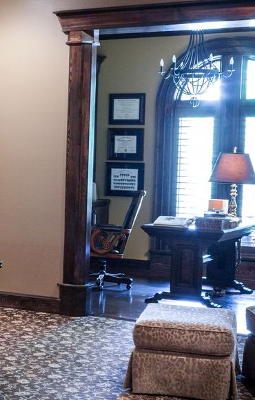 A bedroom with an adjacent home office with classic, wooden furniture