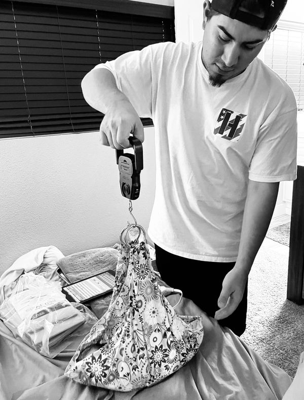 Dad weighing his son during newborn exam