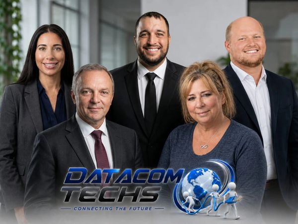 Five professionals posing for a corporate photo with Datacom Techs logo.