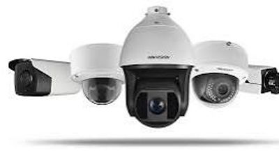 Various types of security cameras displayed in a row.